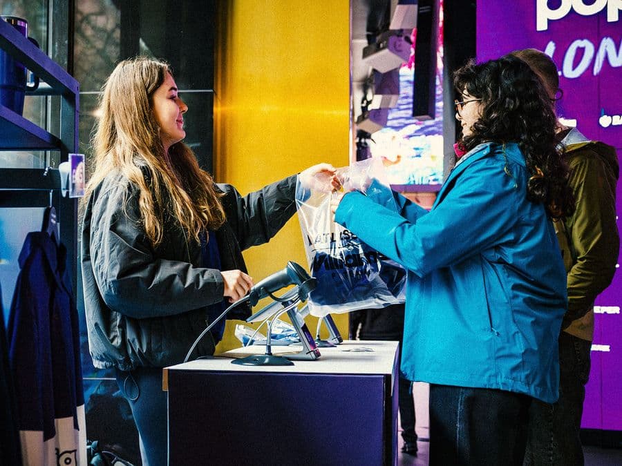 Staff serving a customer at a pop-up store till