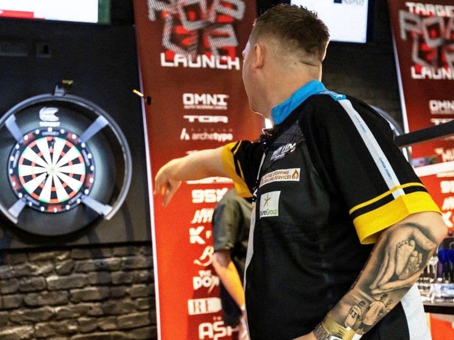 Player throwing at a Target Darts launch stand